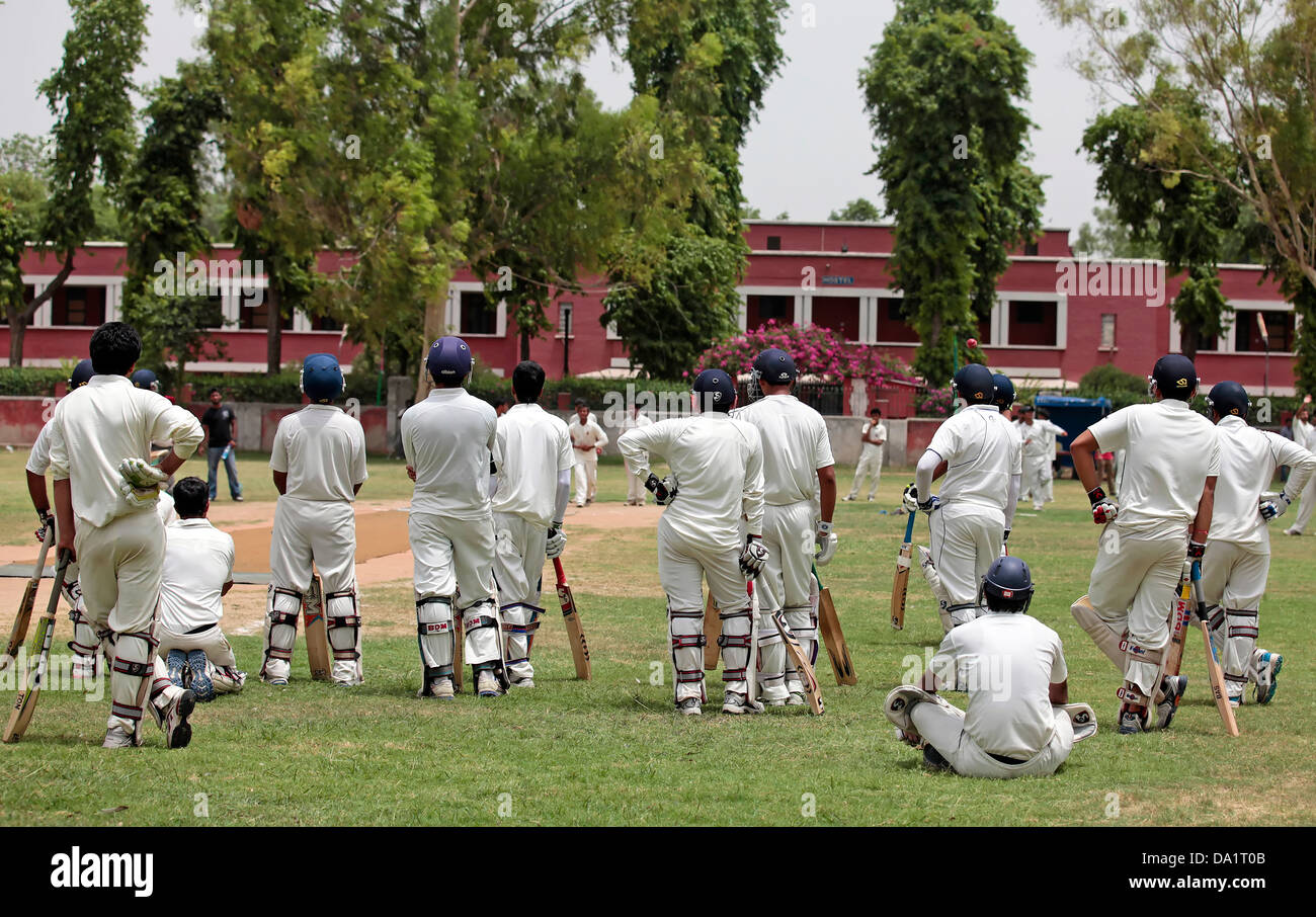 cricket Player wearing white uniform and focused on the game Stock