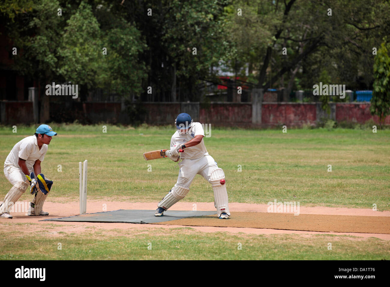 Batsman Hitting Ball During Cricket Match Stock Photo