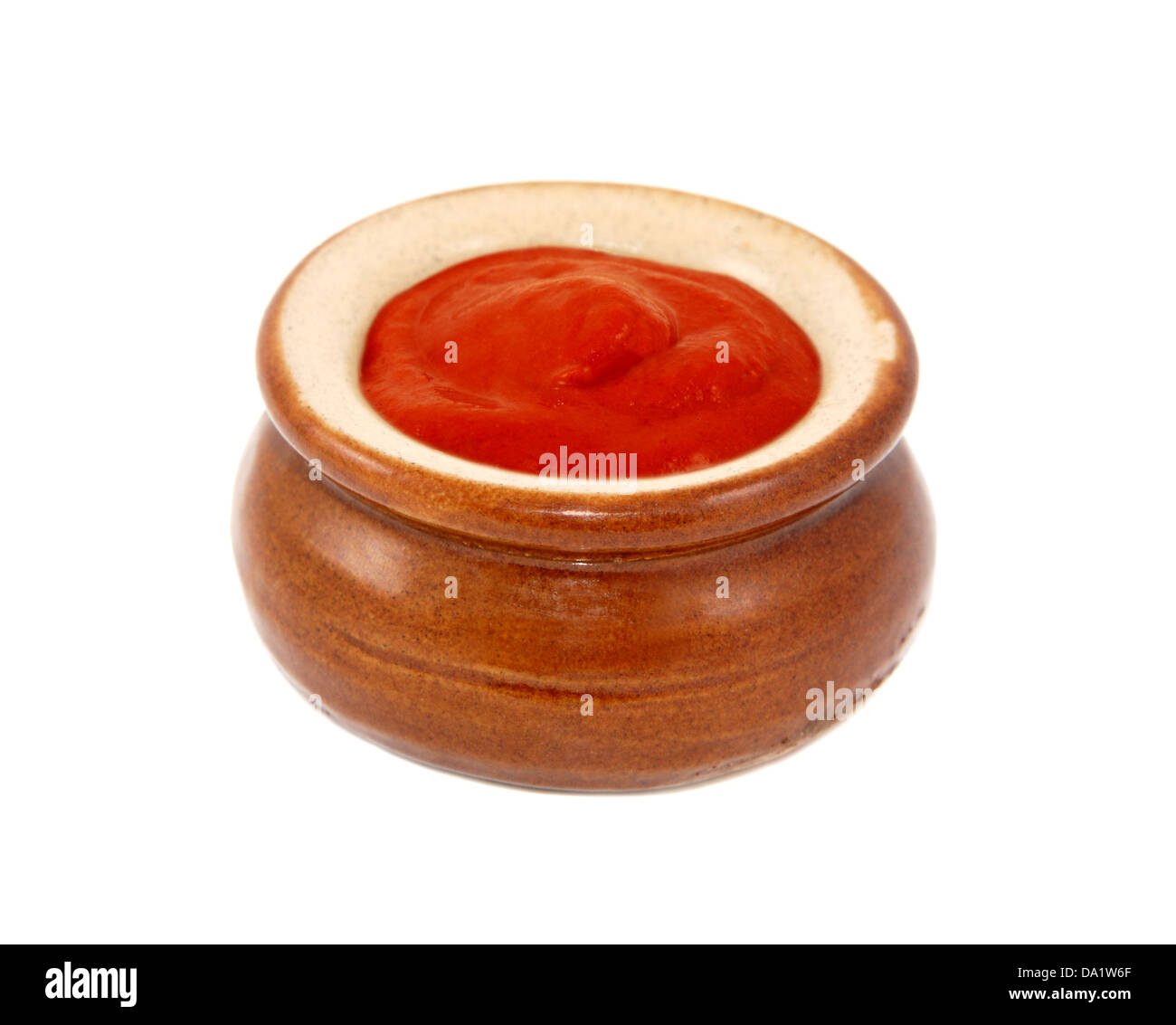 Tomato ketchup served in a small ceramic pot, isolated on a white background Stock Photo