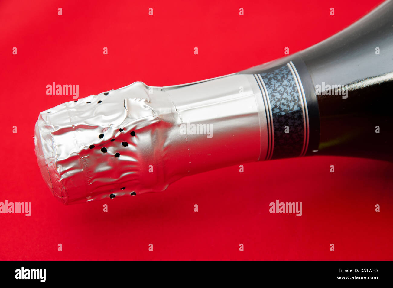bottle of champagne on a red background Stock Photo - Alamy