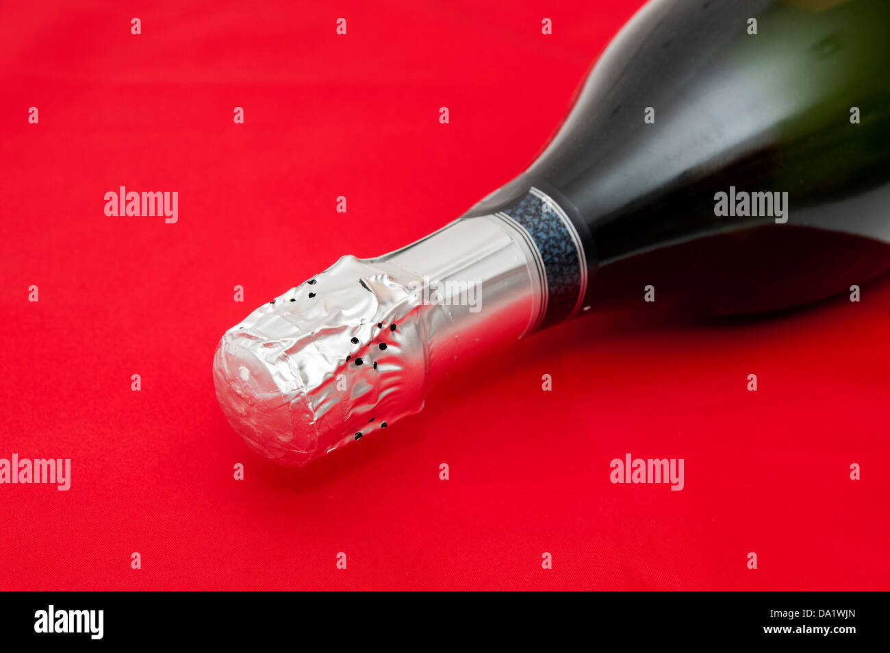 bottle of champagne on a red background Stock Photo - Alamy