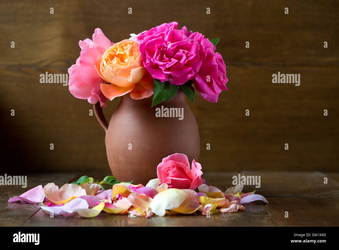 An arrangement of roses in an earthenware vase Stock Photo Alamy