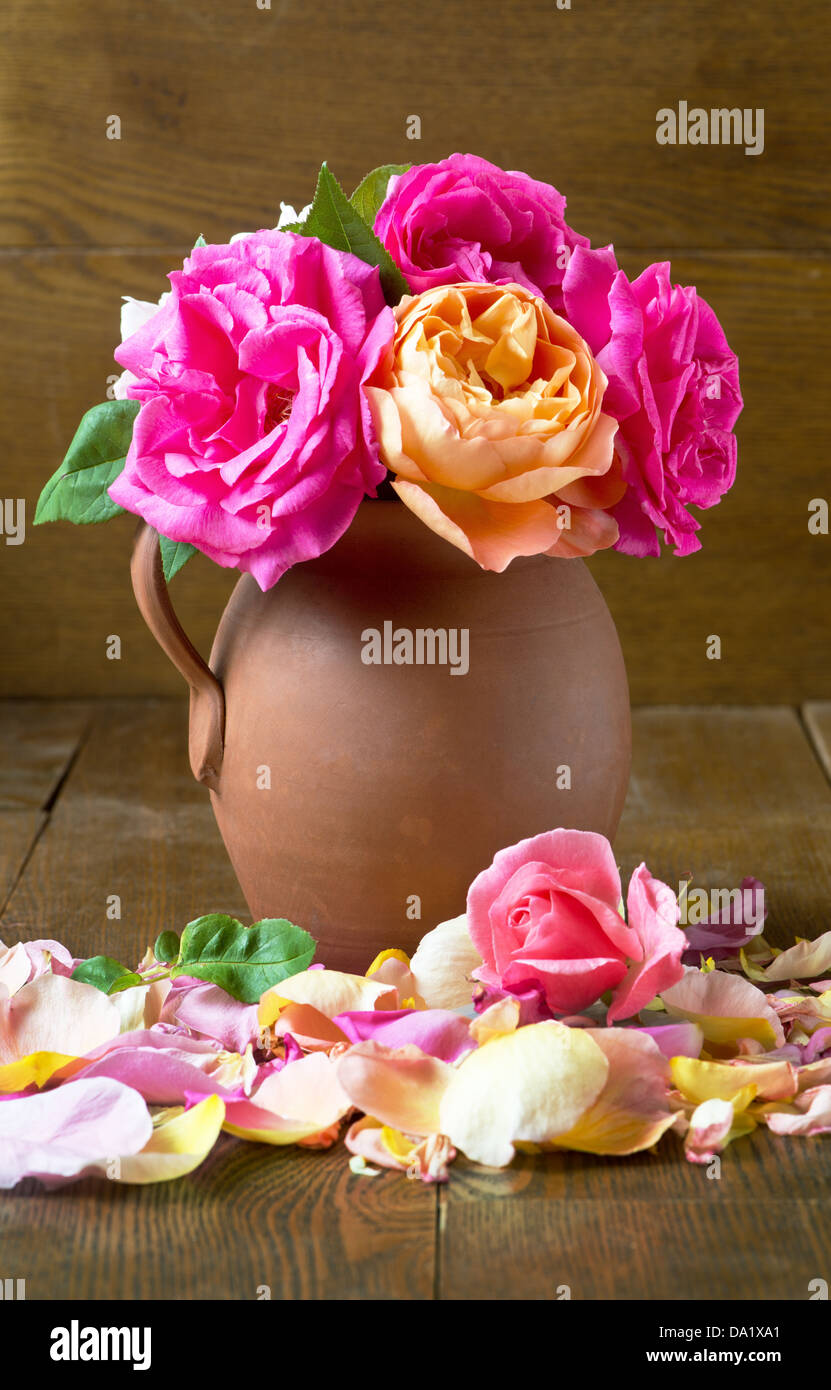 An arrangement of roses in an earthenware vase Stock Photo Alamy
