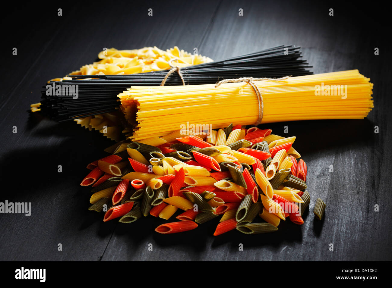 Variety of types and shapes of Italian pasta on black table Stock Photo ...