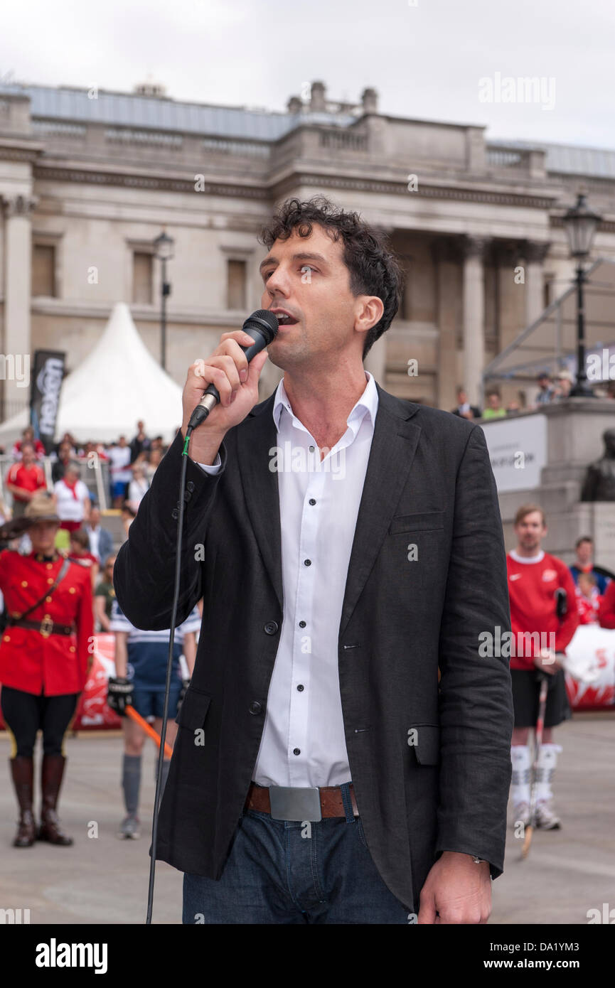 Trafalgar Square, London, UK. Canada Day 2013. Canadian singer Alex Goumad sings the Canadian national anthem at the opening. Stock Photo