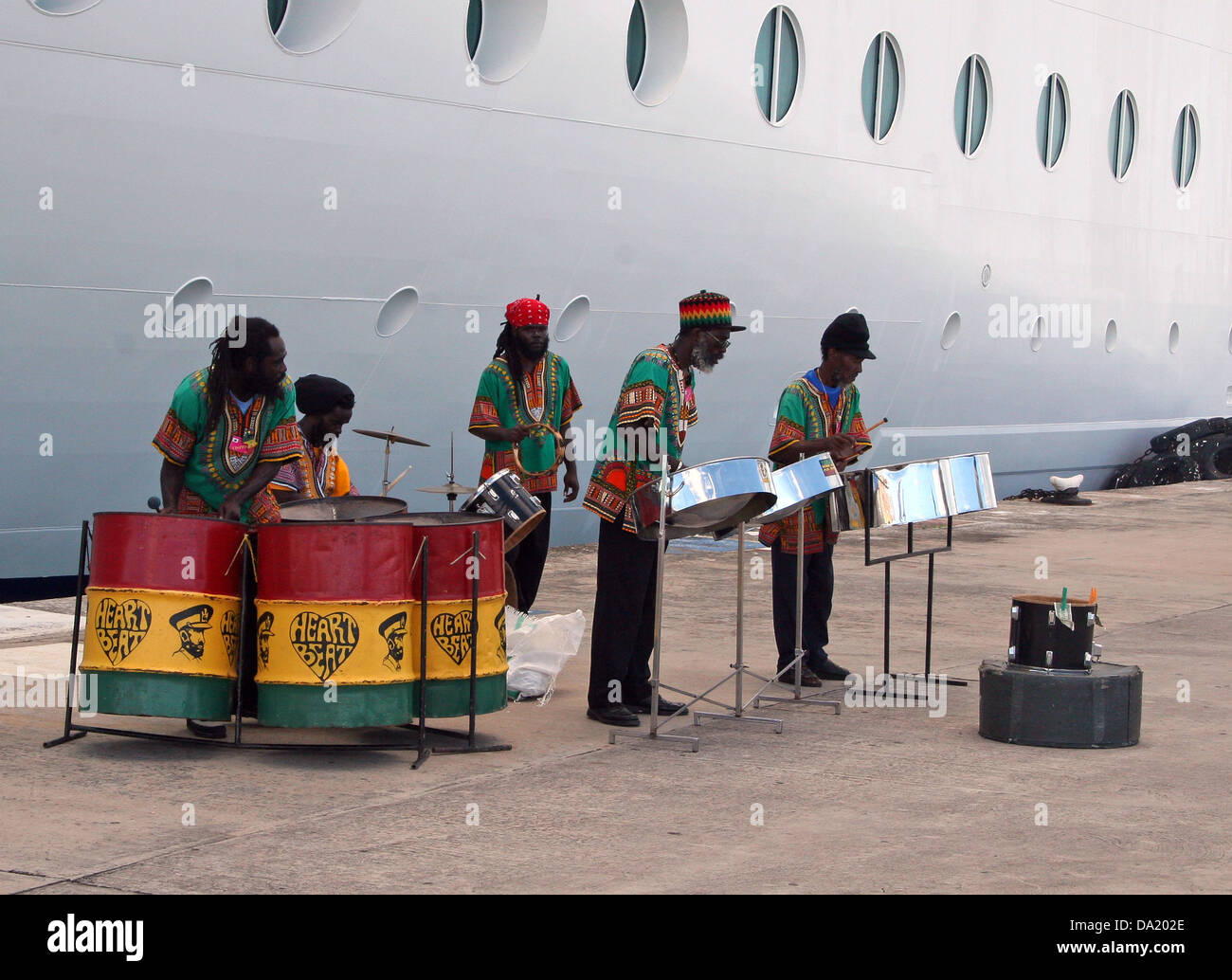 Steel drum band performs on the docks next to a cruise ship, St. John's, Wadadli, Antigua and