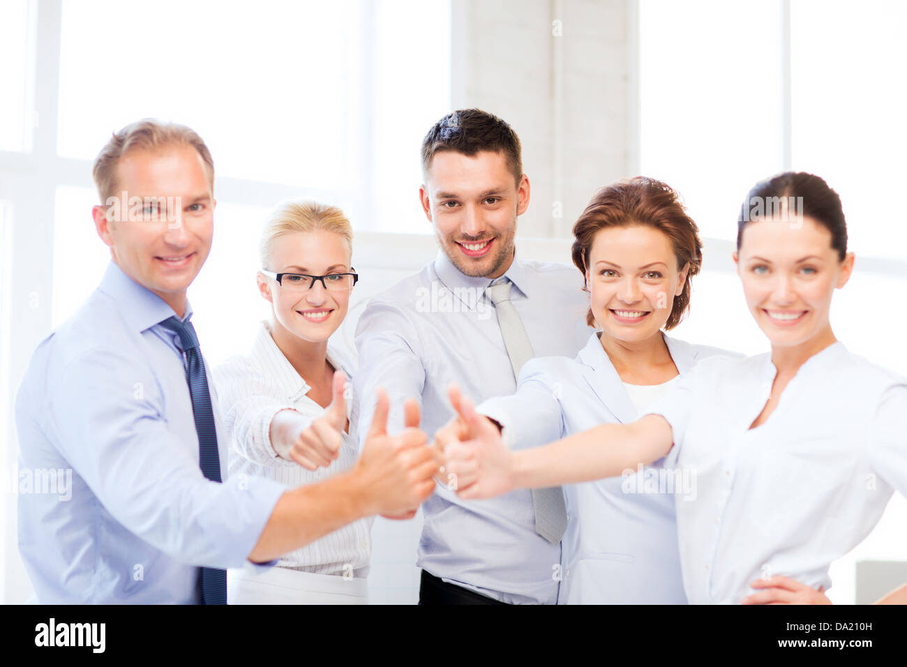 business team showing thumbs up in office Stock Photo - Alamy