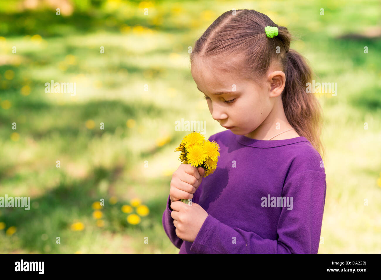 Beautiful little girl with dandelion flower outdoor Stock Photo - Alamy