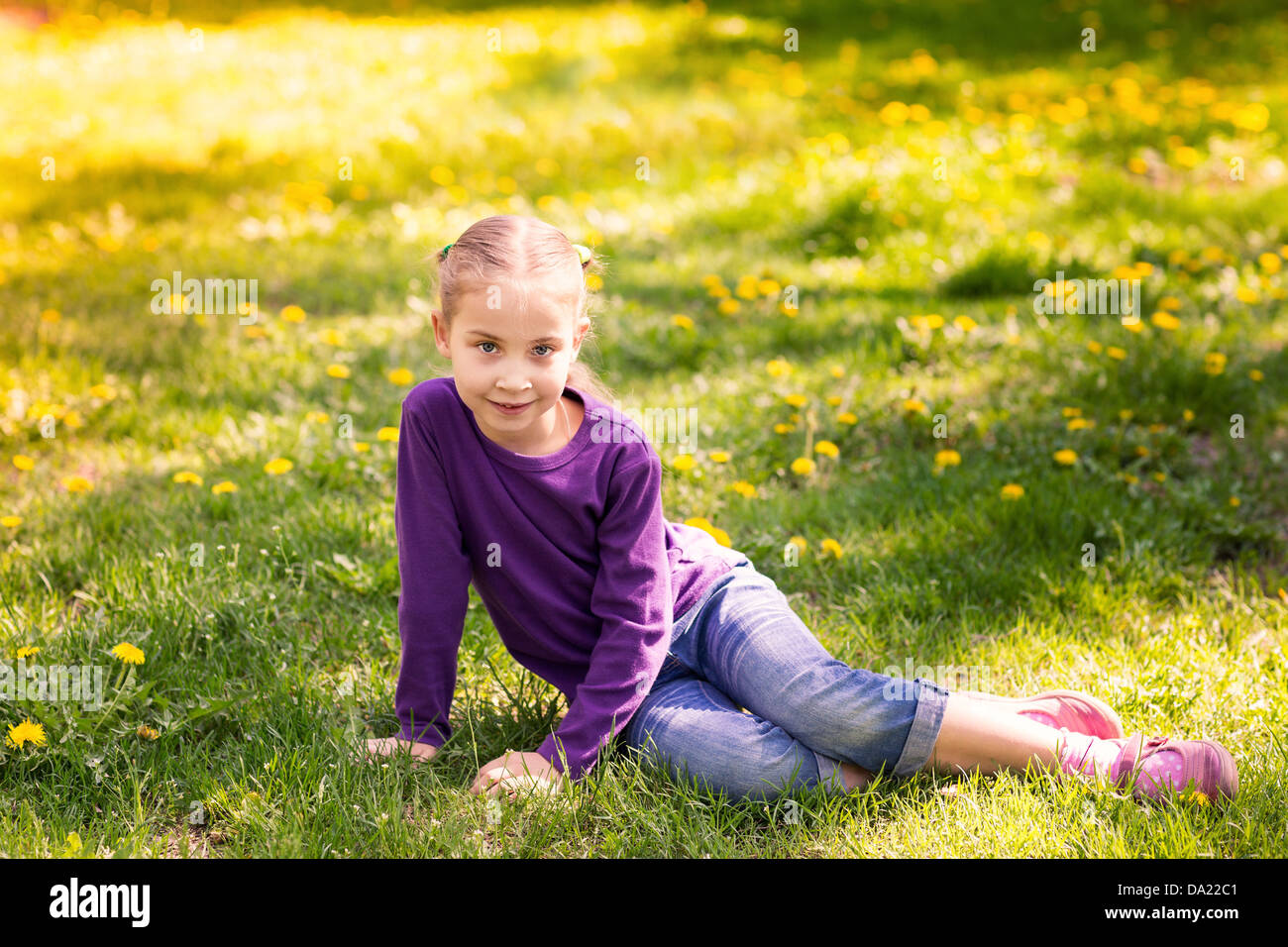 Beautiful little girl with dandelion flower outdoor Stock Photo - Alamy