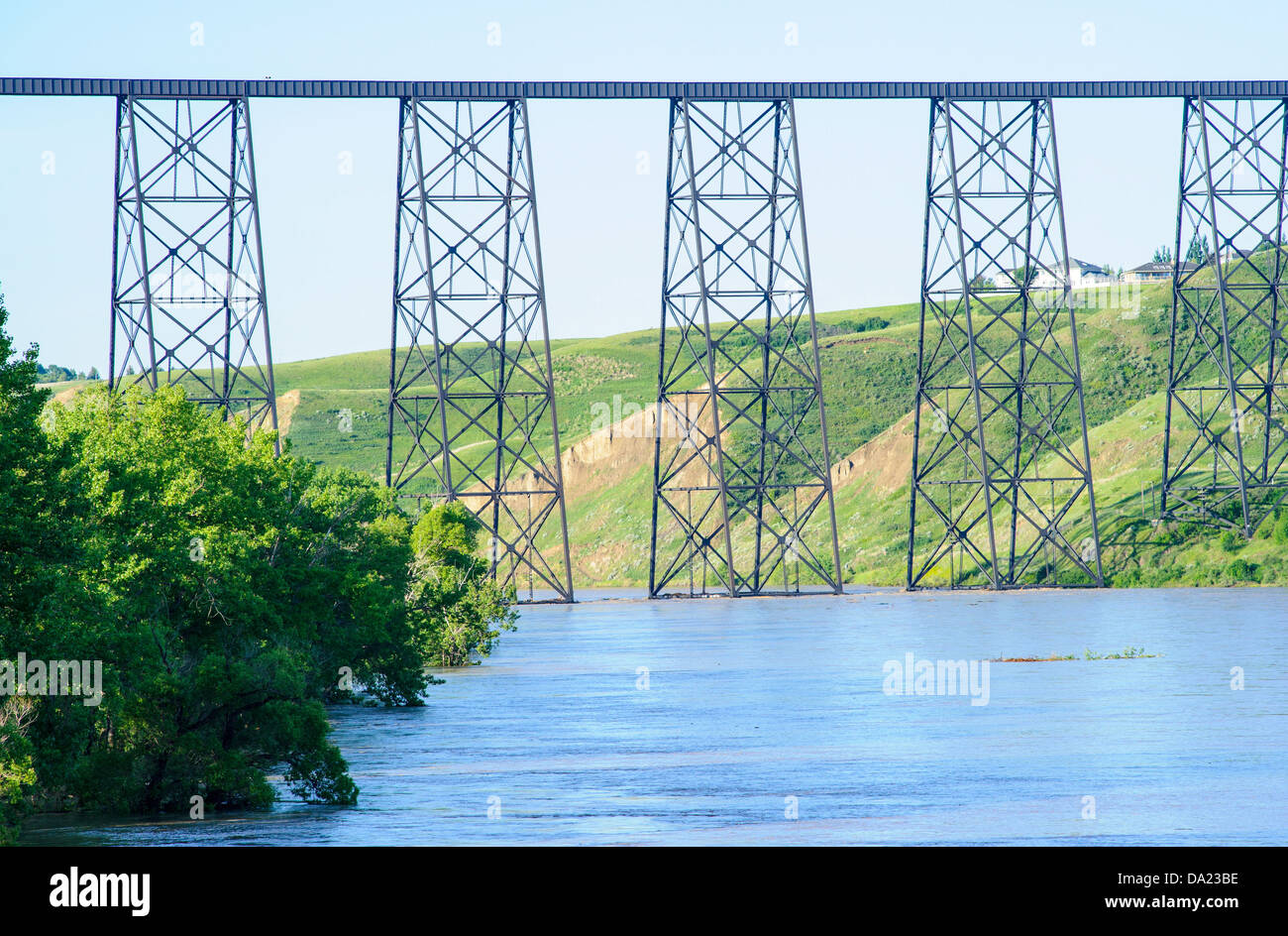 Old Man River with flood waters under high level train bridge at