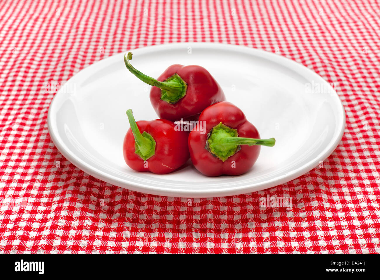 red pepper or paprika on white plate served on kitchen table. Stock Photo
