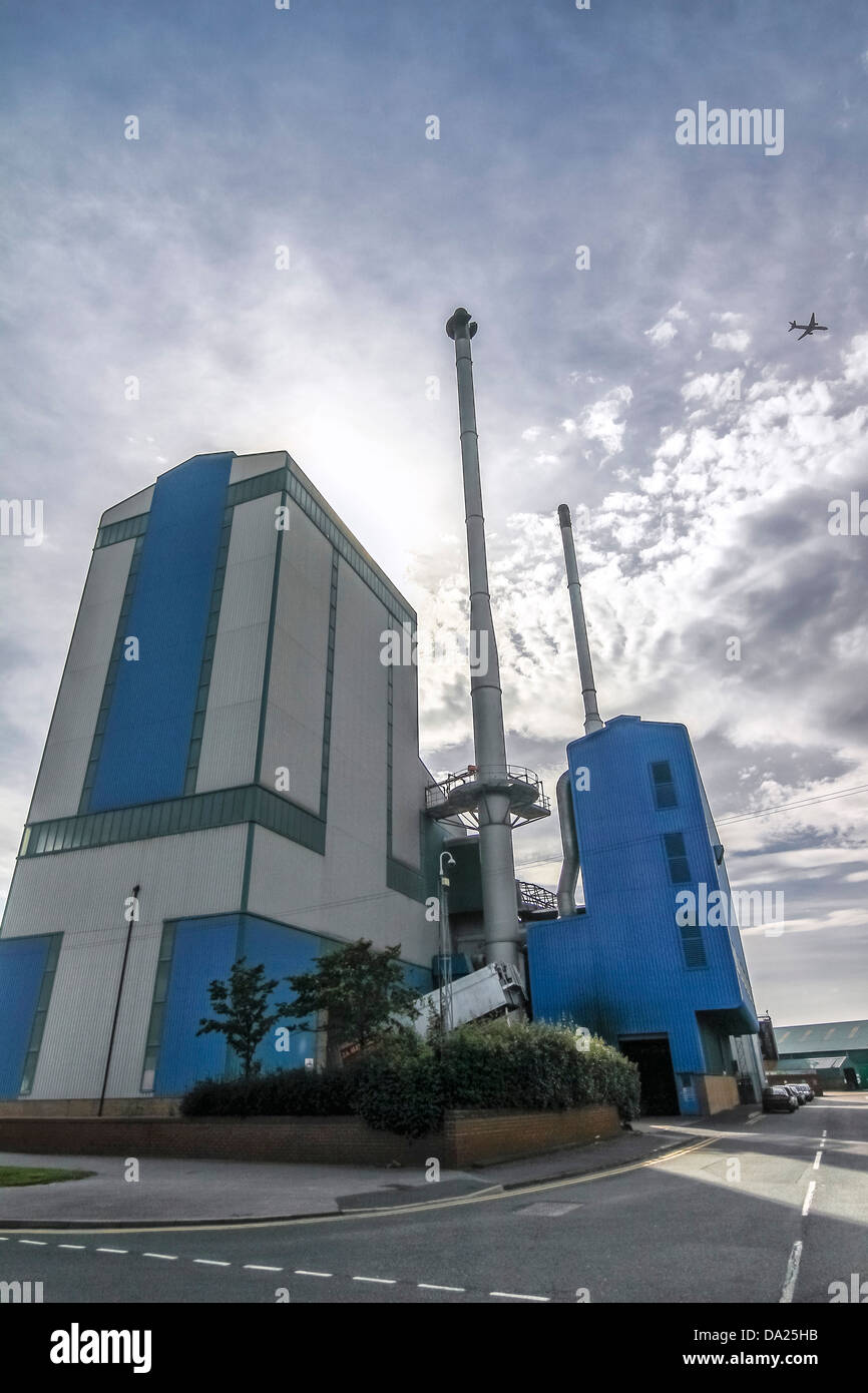 A big blue & white factory is on the corner of a road in an Stock Photo -  Alamy