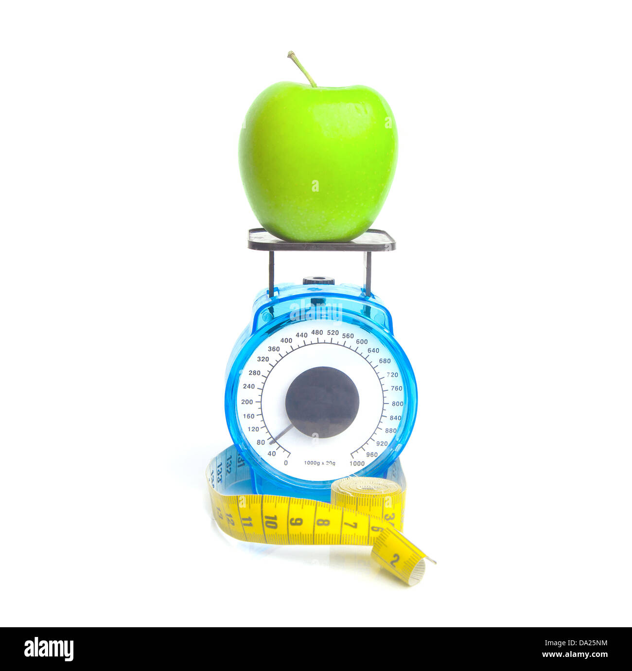 Weighing a green apple: weight loss concept Stock Photo