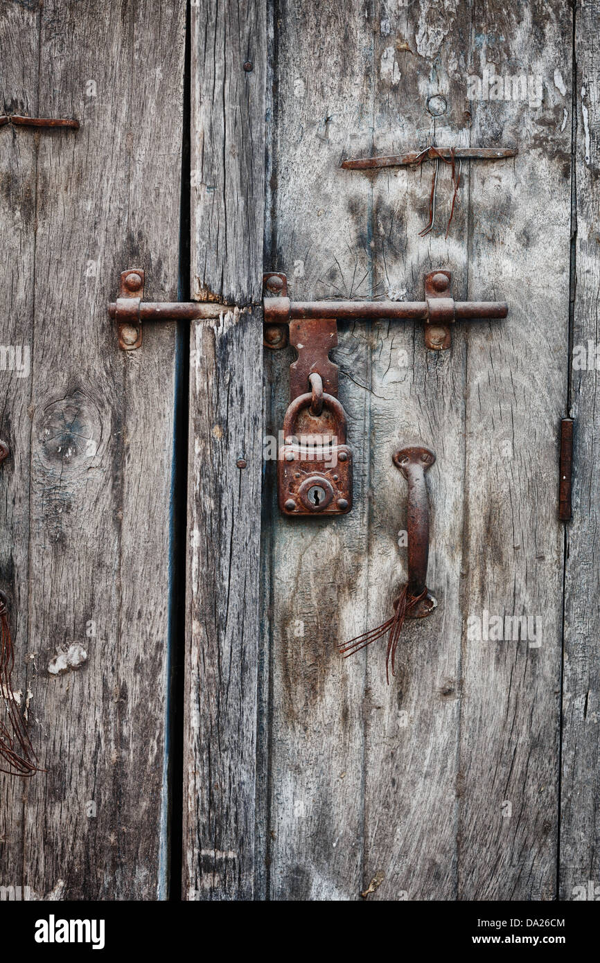 Rusty padlock on an old wooden door of the indian house Stock Photo