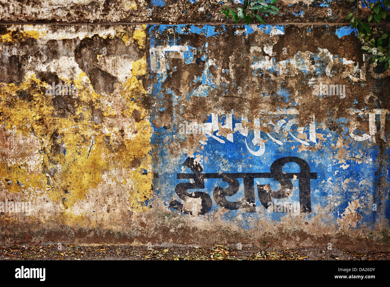 Grunge concrete wall with fragments of Indian inscriptions. Udaipur ...