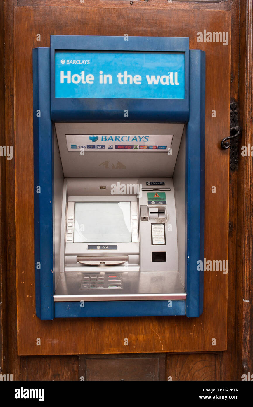 Barclays bank ATM machine in Eton, Berkshire set into an old wooden door, with the inscription 'Hole in the wall'. Stock Photo