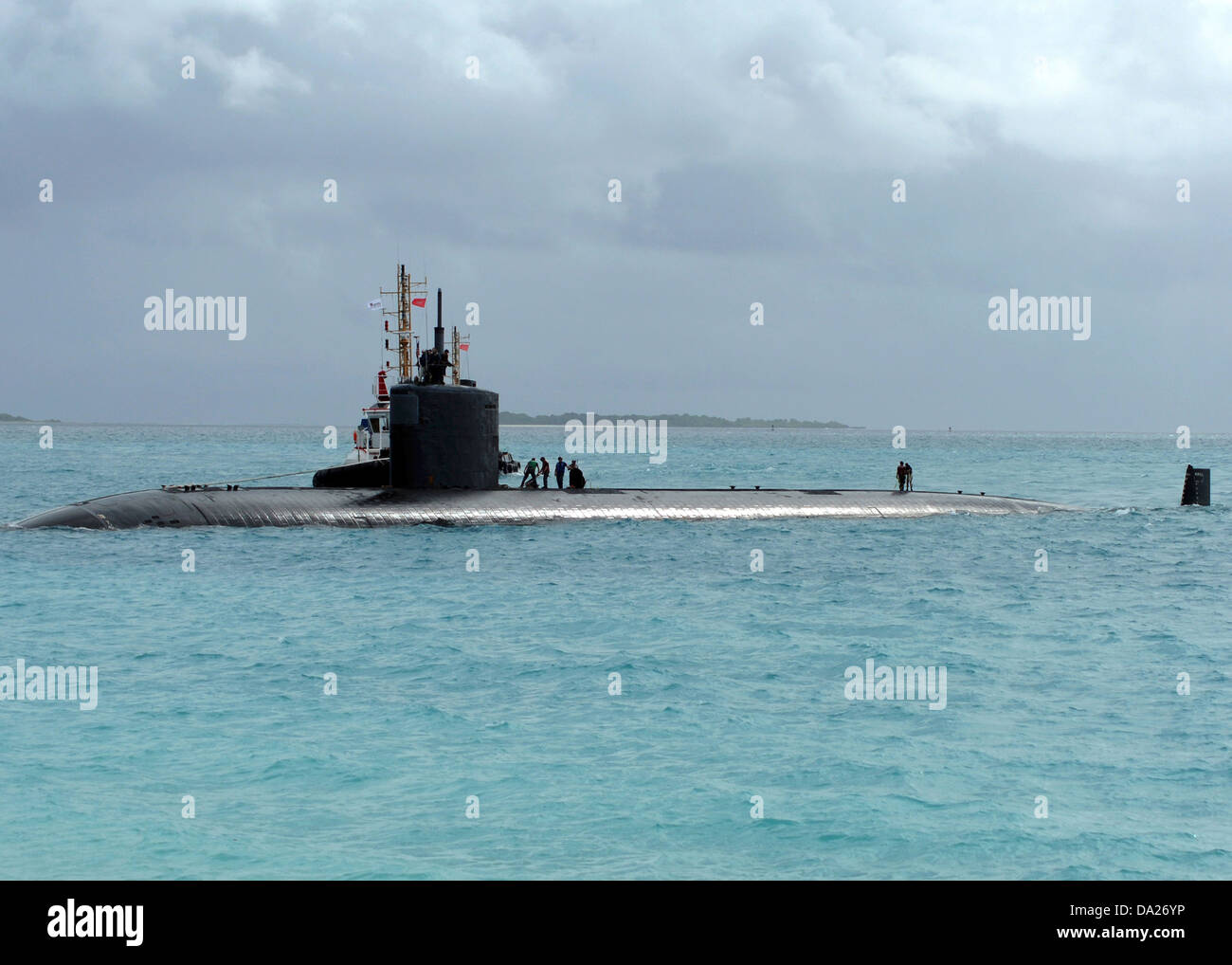 Tugboats assist the Los Angeles class nuclear attack submarine USS Springfield on arrival at the US Navy Support Facility June 17, 2013 in Diego Garcia. Stock Photo