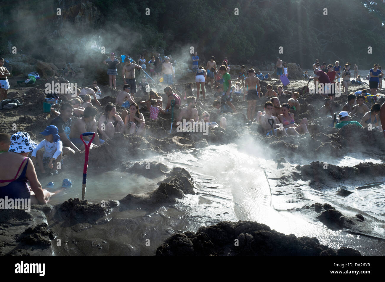 dh Hot Water Beach COROMANDEL NEW ZEALAND People lying in hot water springs thermal pools peninsula Stock Photo