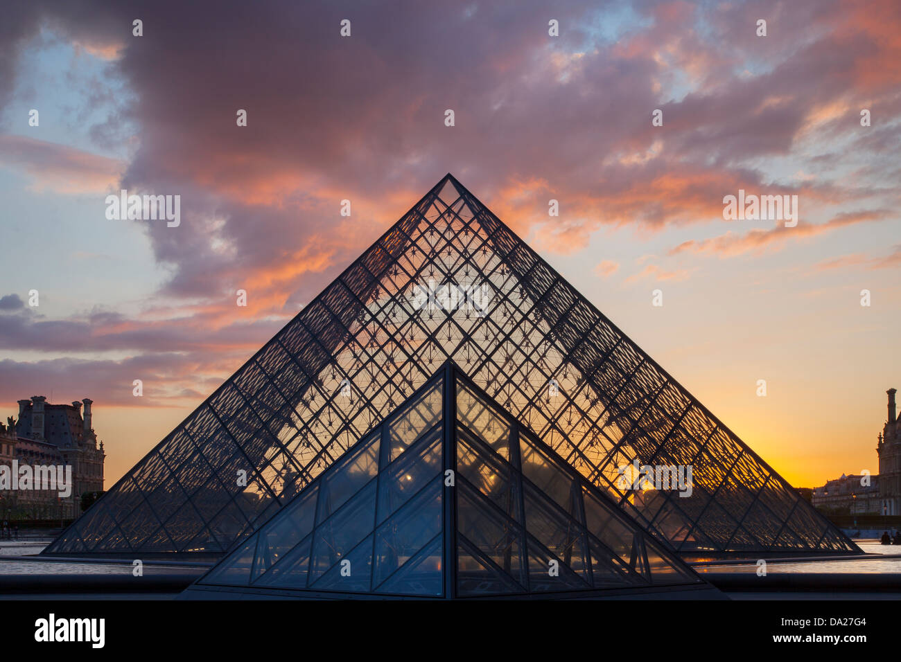 Sunset behind the glass pyramid of Musee du Louvre, Paris France Stock Photo