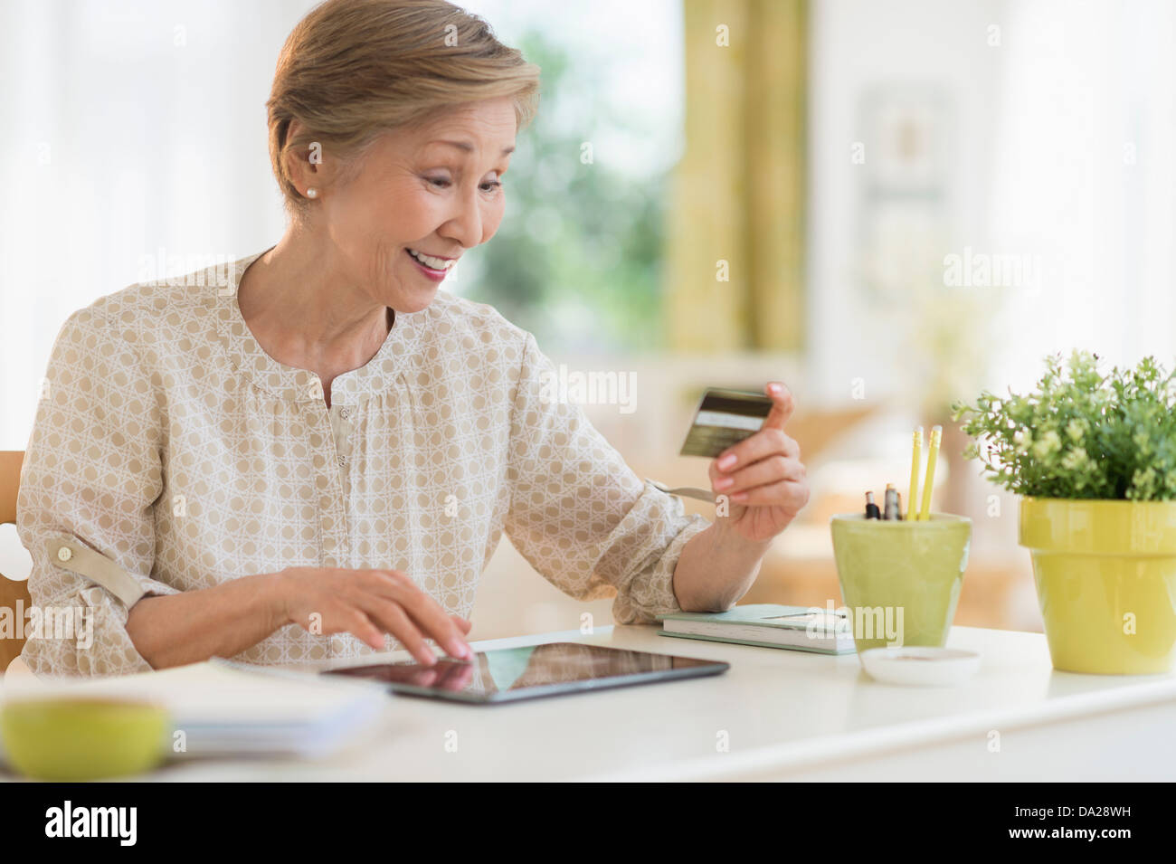 Senior woman shopping online with tablet pc Stock Photo