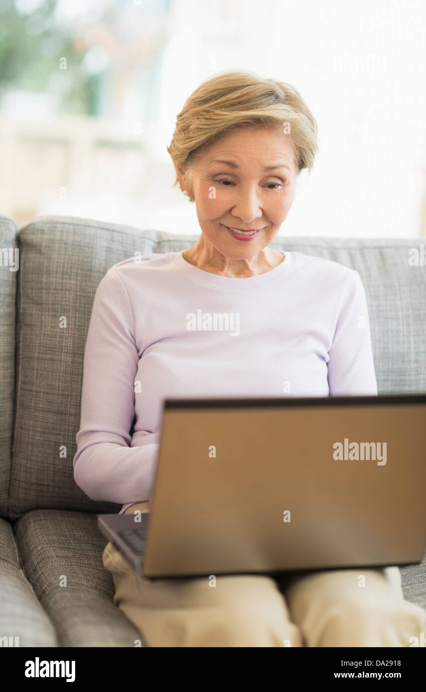 Senior woman sitting laptop hi-res stock photography and images - Alamy