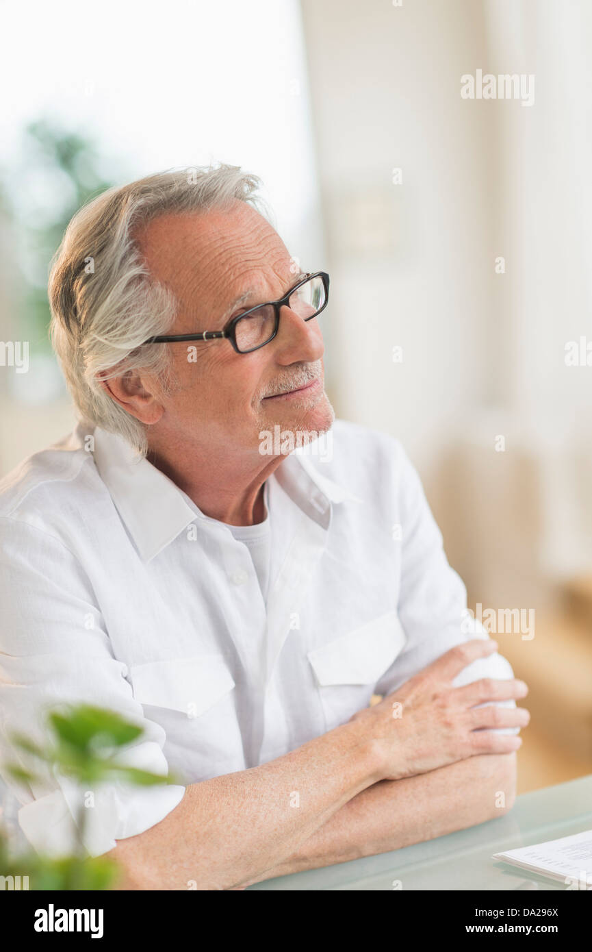 Portrait of senior man sitting hi-res stock photography and images - Alamy