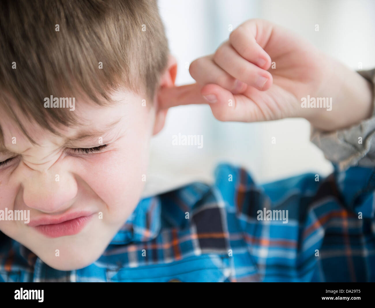 Portrait of boy (45) sticking fingers in his ears Stock Photo Alamy