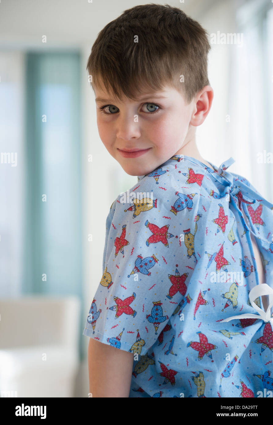 Portrait of boy (4-5) in surgical gown Stock Photo
