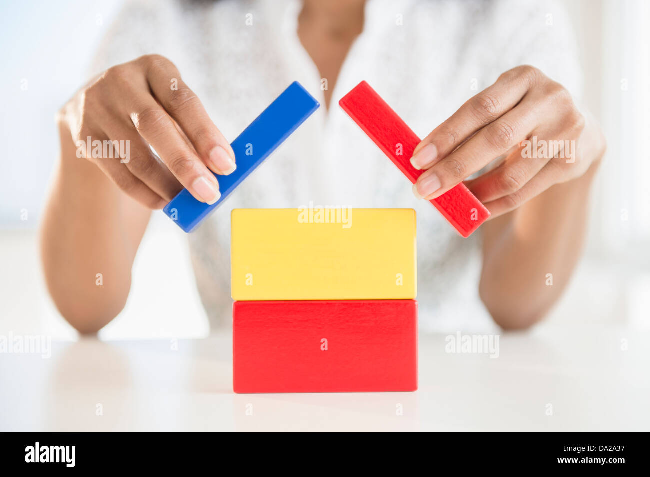 Close up of woman's hands holding blocks Stock Photo