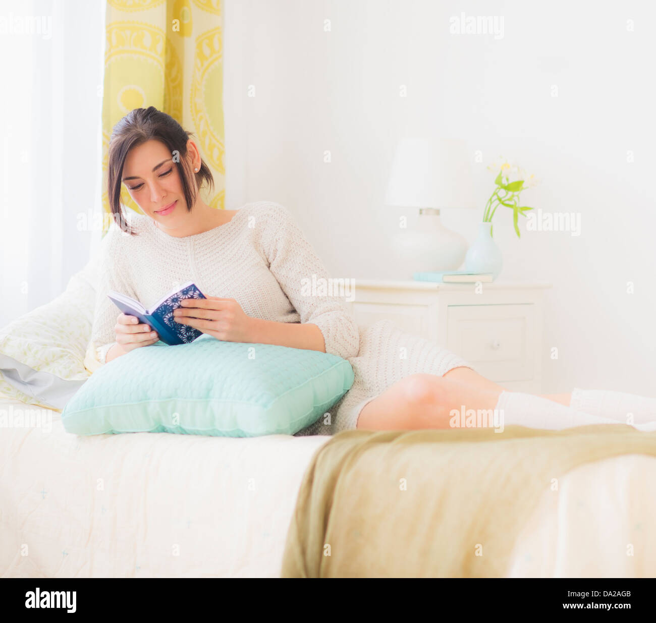 https://c8.alamy.com/comp/DA2AGB/woman-leaning-against-pillow-in-bed-and-reading-book-DA2AGB.jpg