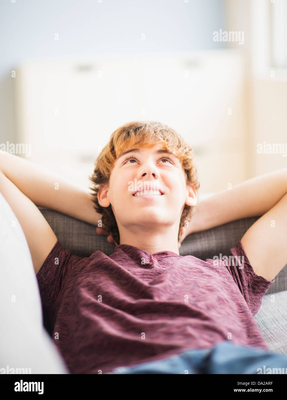 Teenage boy (14-15) laying down and looking up Stock Photo
