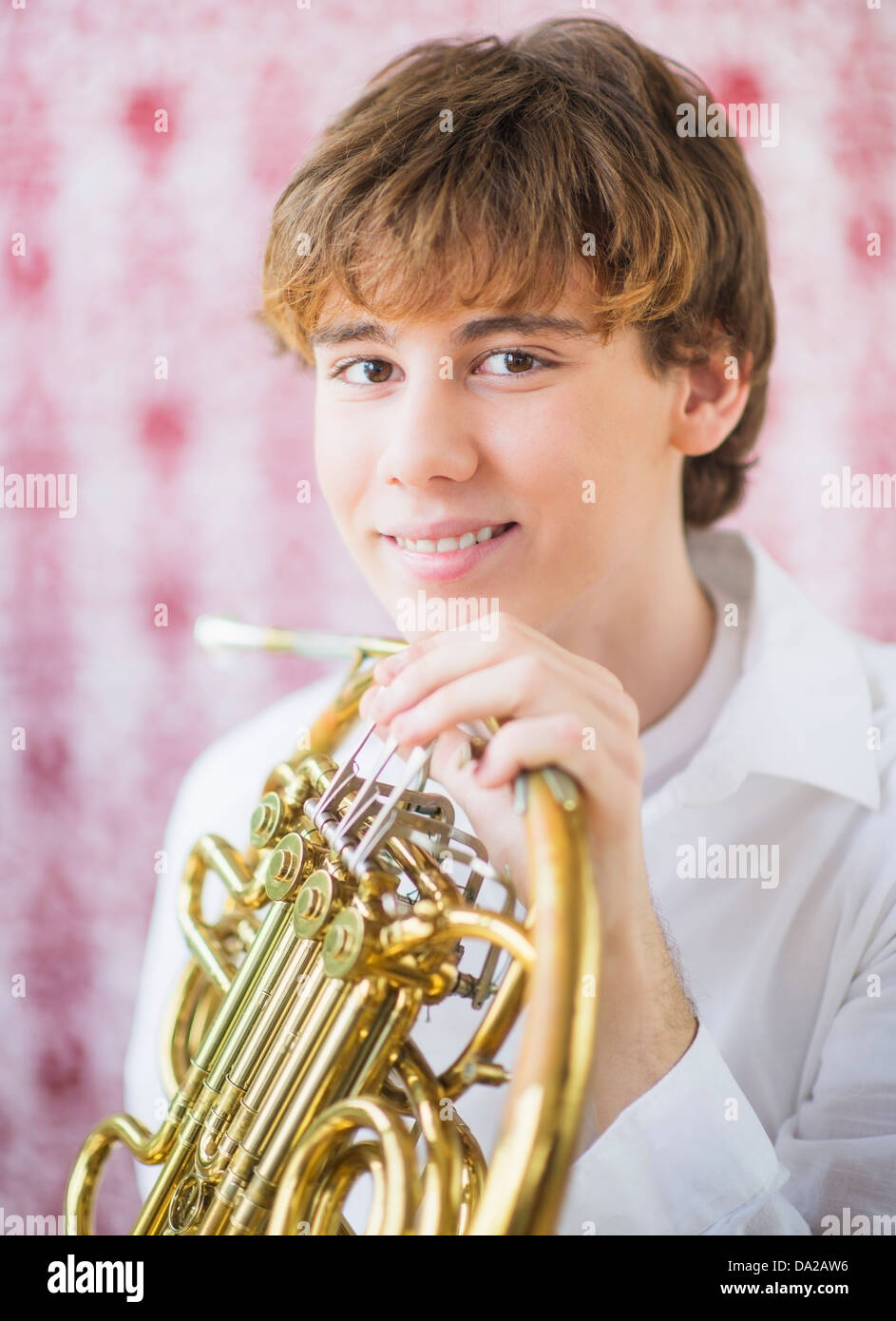 Teenage boy (1415) holding french horn Stock Photo Alamy