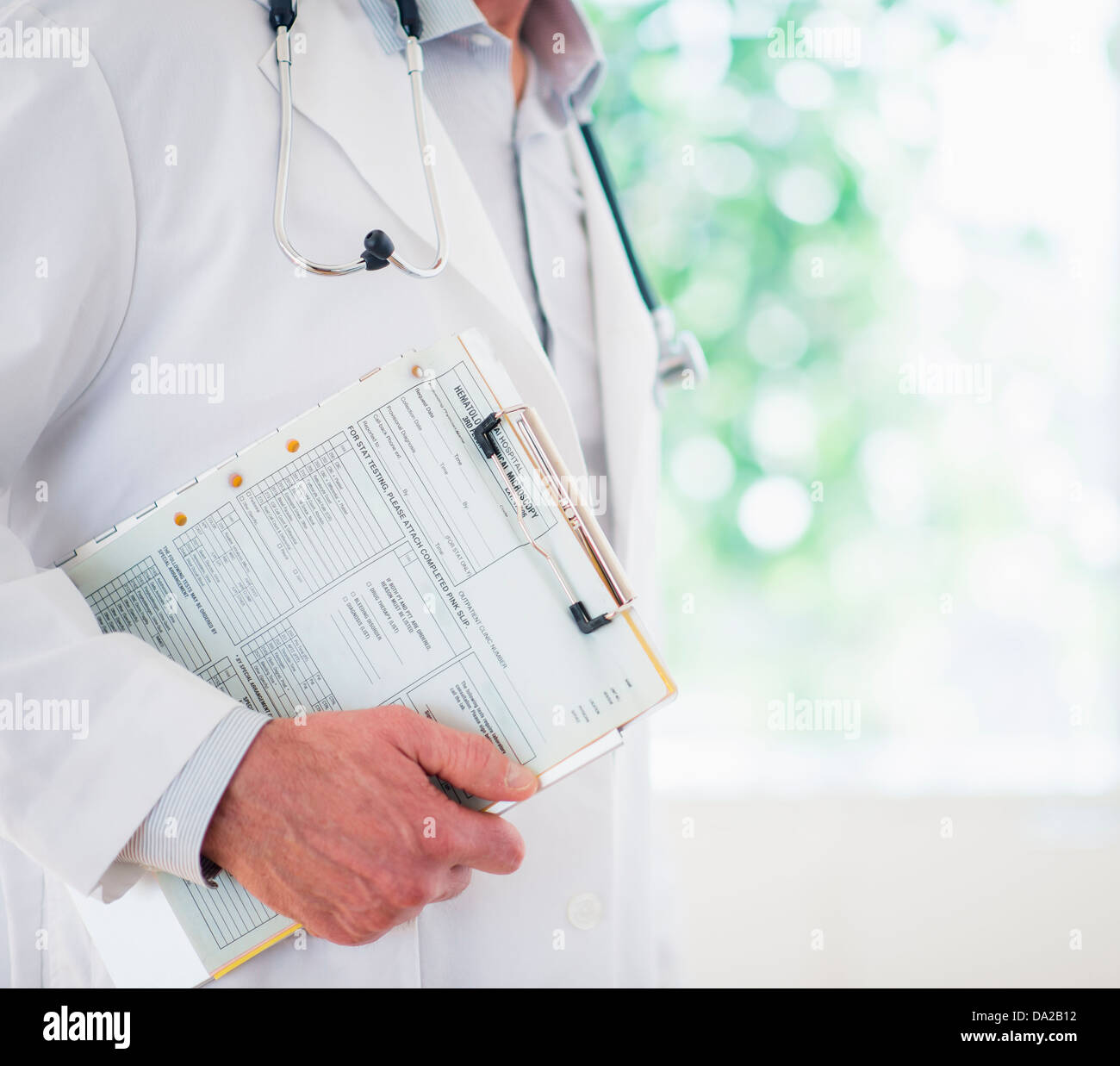 Mid section of doctor holding medical record Stock Photo Alamy