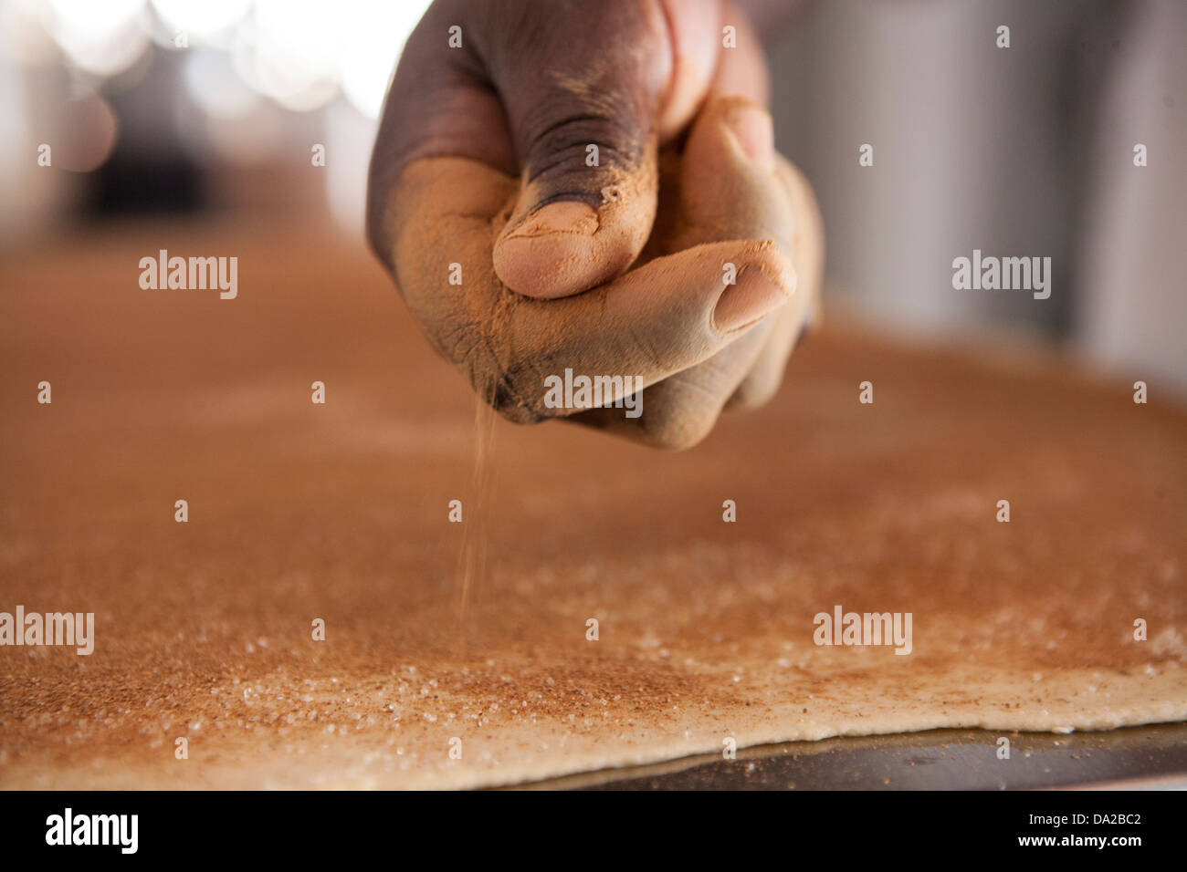 african american women making cinnamon buns from scratch Stock Photo