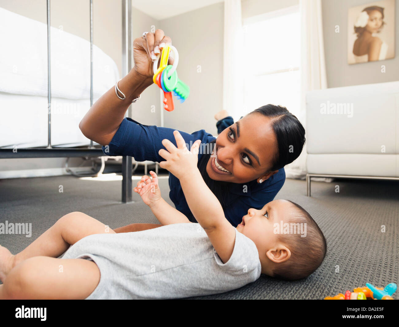 mother-playing-with-her-son-2-5-months-on-the-floor-of-living-room