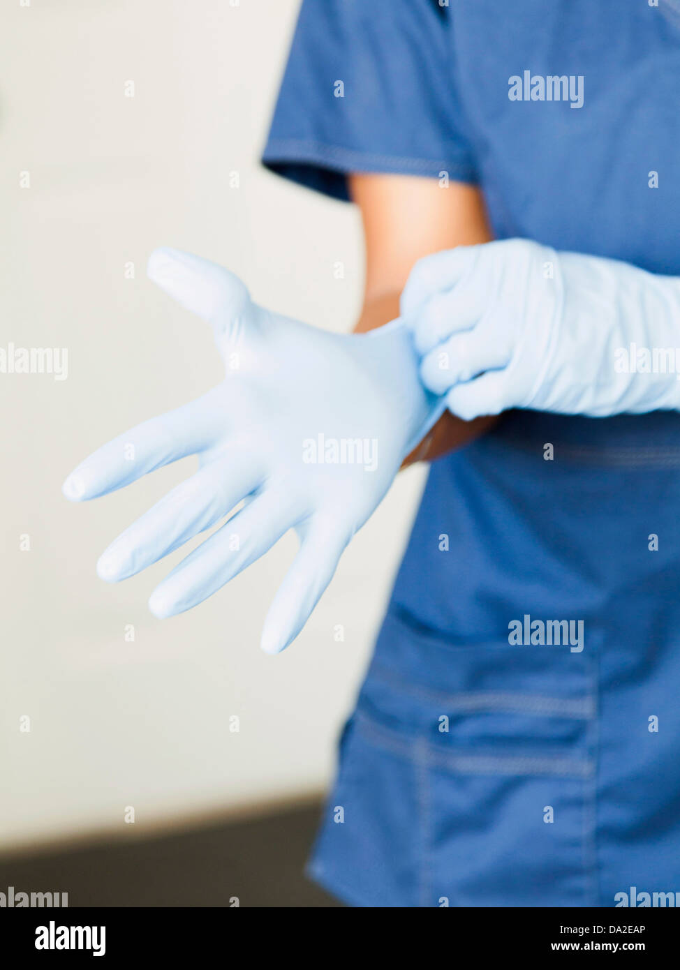 Closeup of nurses hands putting on surgical gloves Stock Photo Alamy