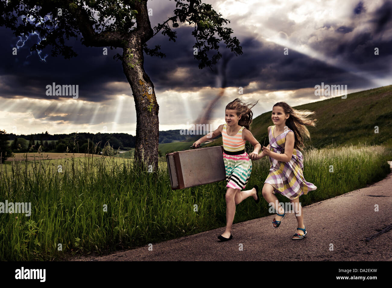 little girls getting themselves to safety from a storm Stock Photo
