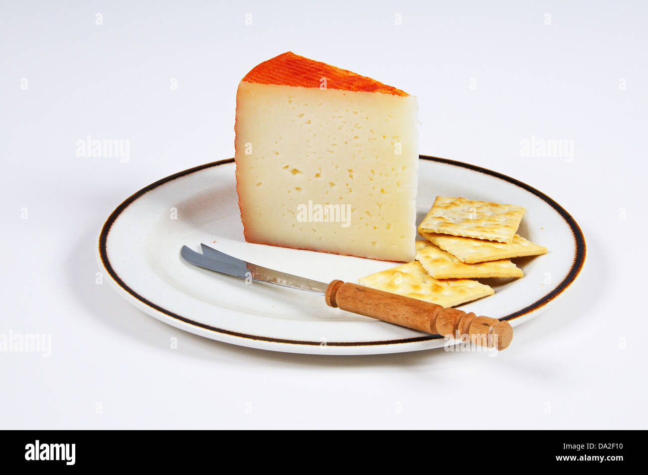 Manchego cheese with crackers and a cheese knife, Andalucia, Spain, Western Europe Stock Photo