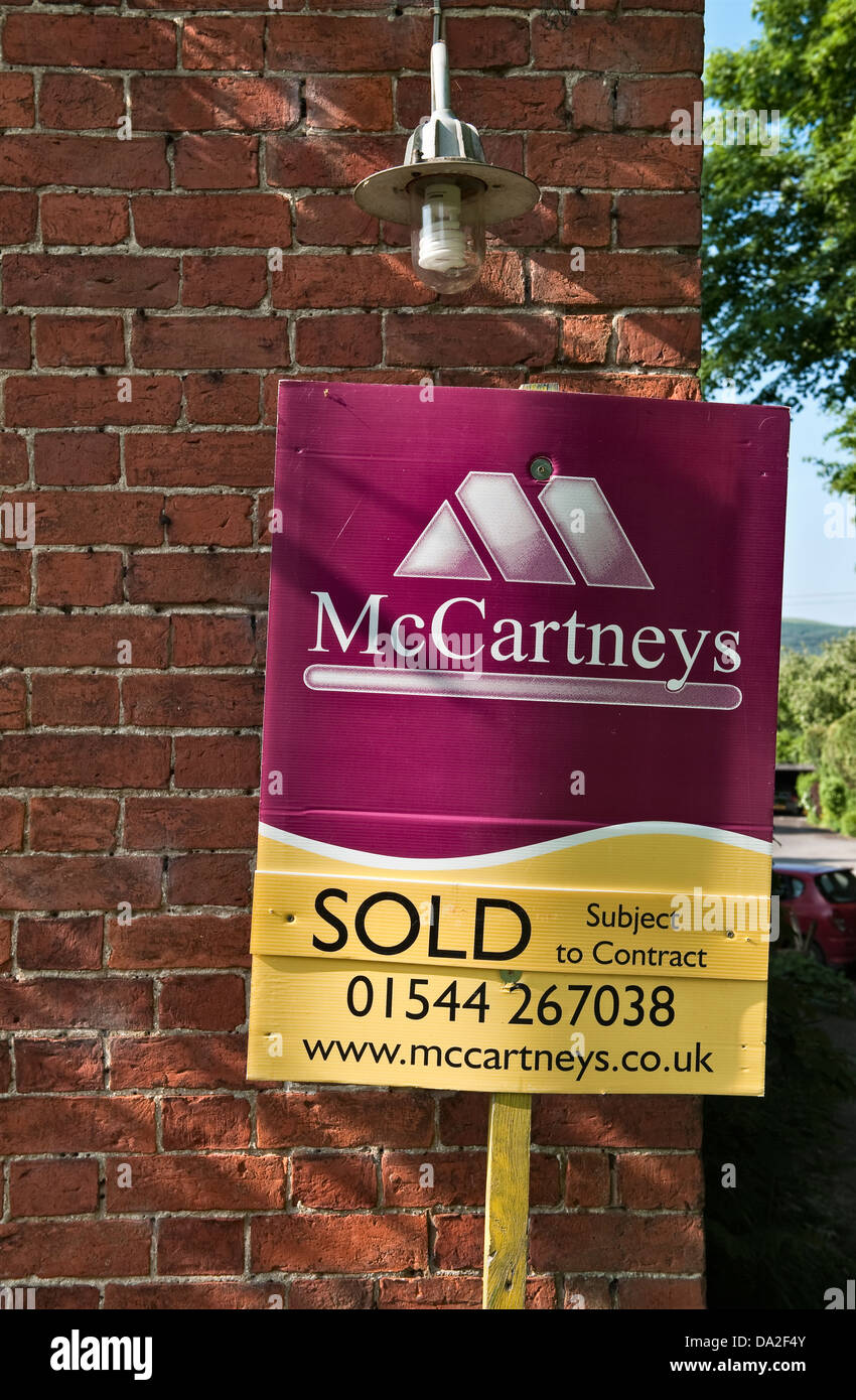 An estate agent's 'sold' sign on a property in Presteigne, Powys, Wales