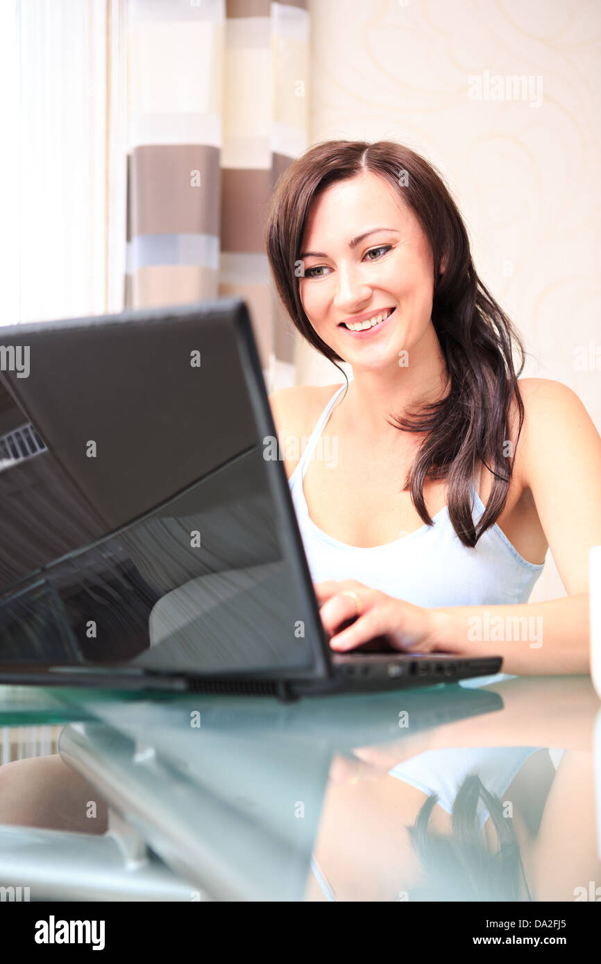 young woman working with a laptop in the living room Stock Photo