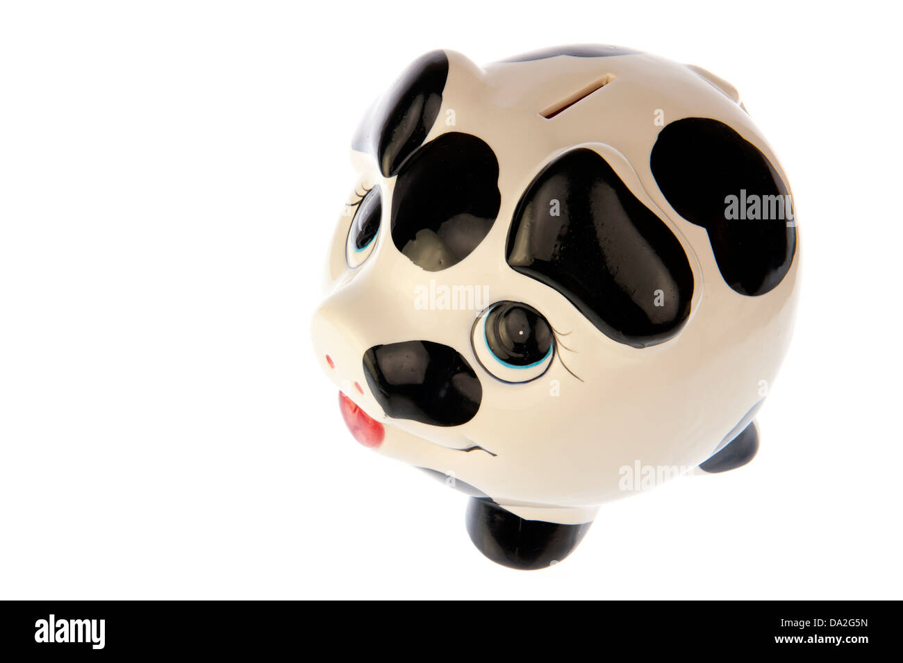 Piggy bank with black and white cow spots, top front left side look, isolated in white background Stock Photo