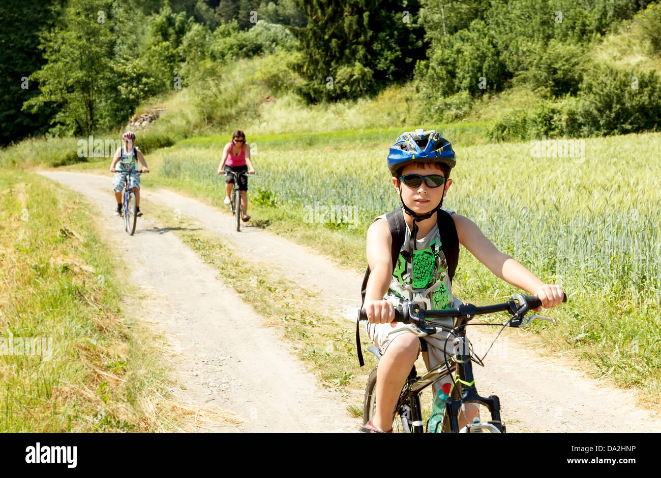 Teenager riding bicycle on trip in sunny day Stock Photo