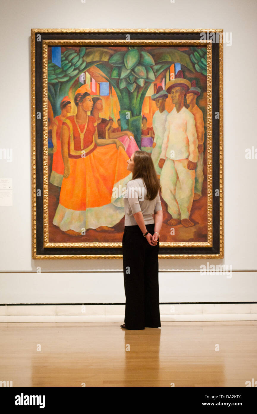 London, UK - 2 July 2013: A Royal Academy of Arts employee stands next to a work by Diego Rivera entitled 'Dance in Tehuantepec, 1928' at the exhibition 'Mexico: A Revolution in Art, 1910–1940' which opens on the 6th of July. The show features over 120 paintings and photographs and examines the intense period of artistic creativity that took place in Mexico at the beginning of the 20th century. Credit:  Piero Cruciatti/Alamy Live News Stock Photo
