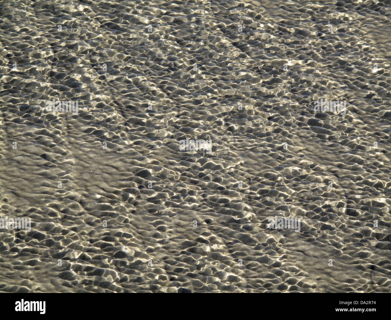 Random, abstract patterns created by the tide on the sands of Worthing Beach, West Sussex, UK Stock Photo