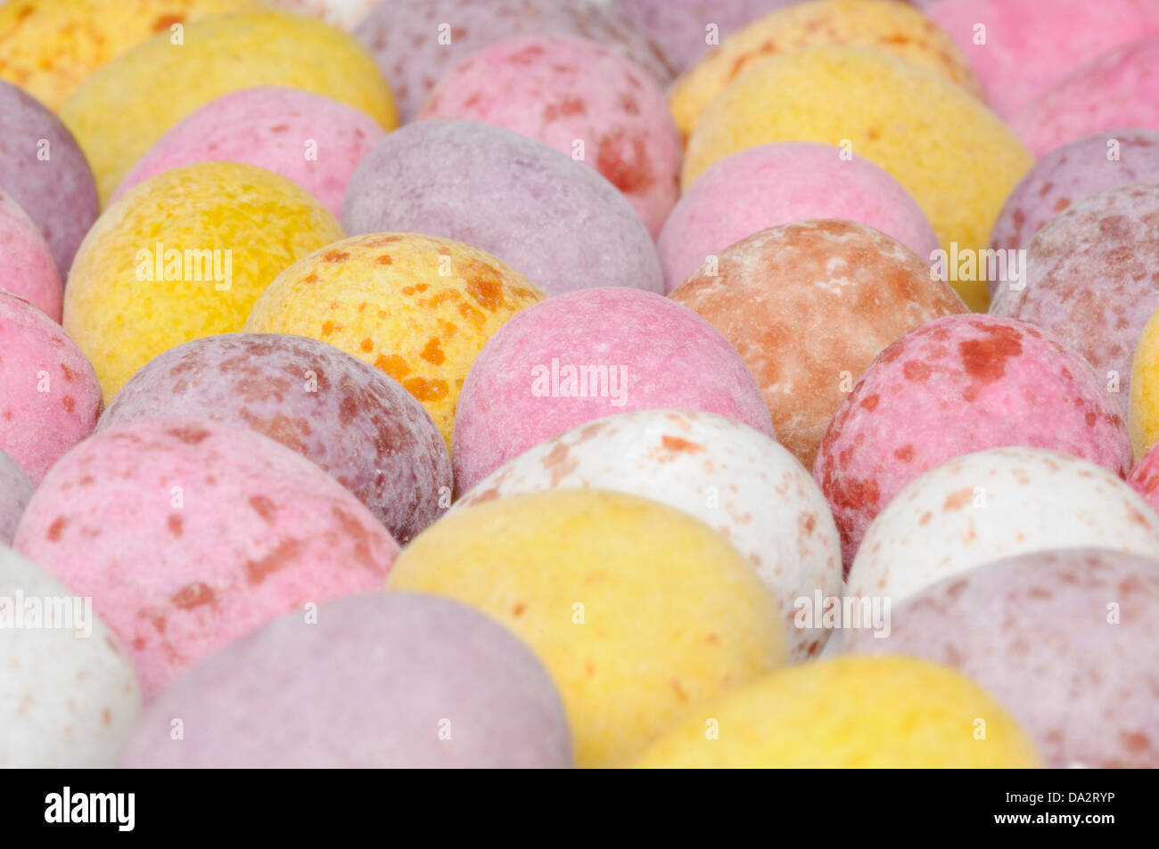 A shot of a pile of mini chocolate easter eggs on a plain white background. Stock Photo