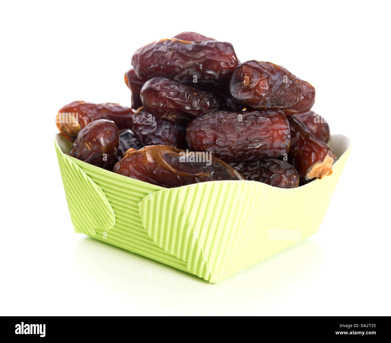 Kurma dried date palm fruits, ramadan food which eaten in fasting month. Pile of fresh dried date fruits in paper box. Stock Photo