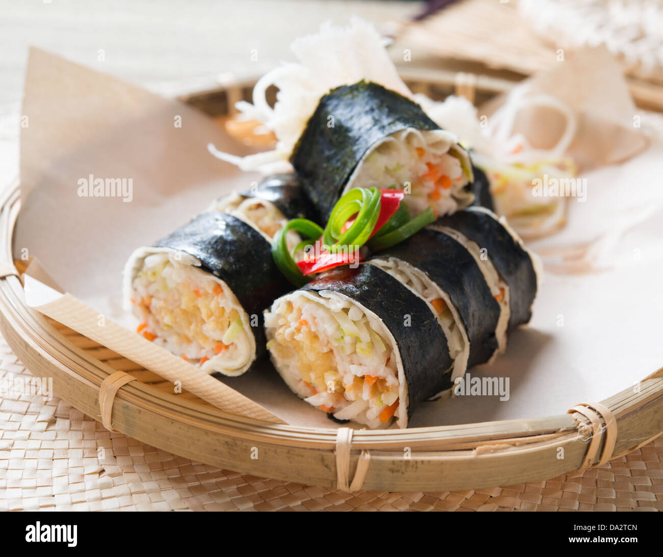 Closeup of a Singapore popiah fresh spring roll with a filling of turnip, Jicama, bean sprouts, grated carrots, tofu and chopped peanuts. Popiah fresh spring roll. Stock Photo