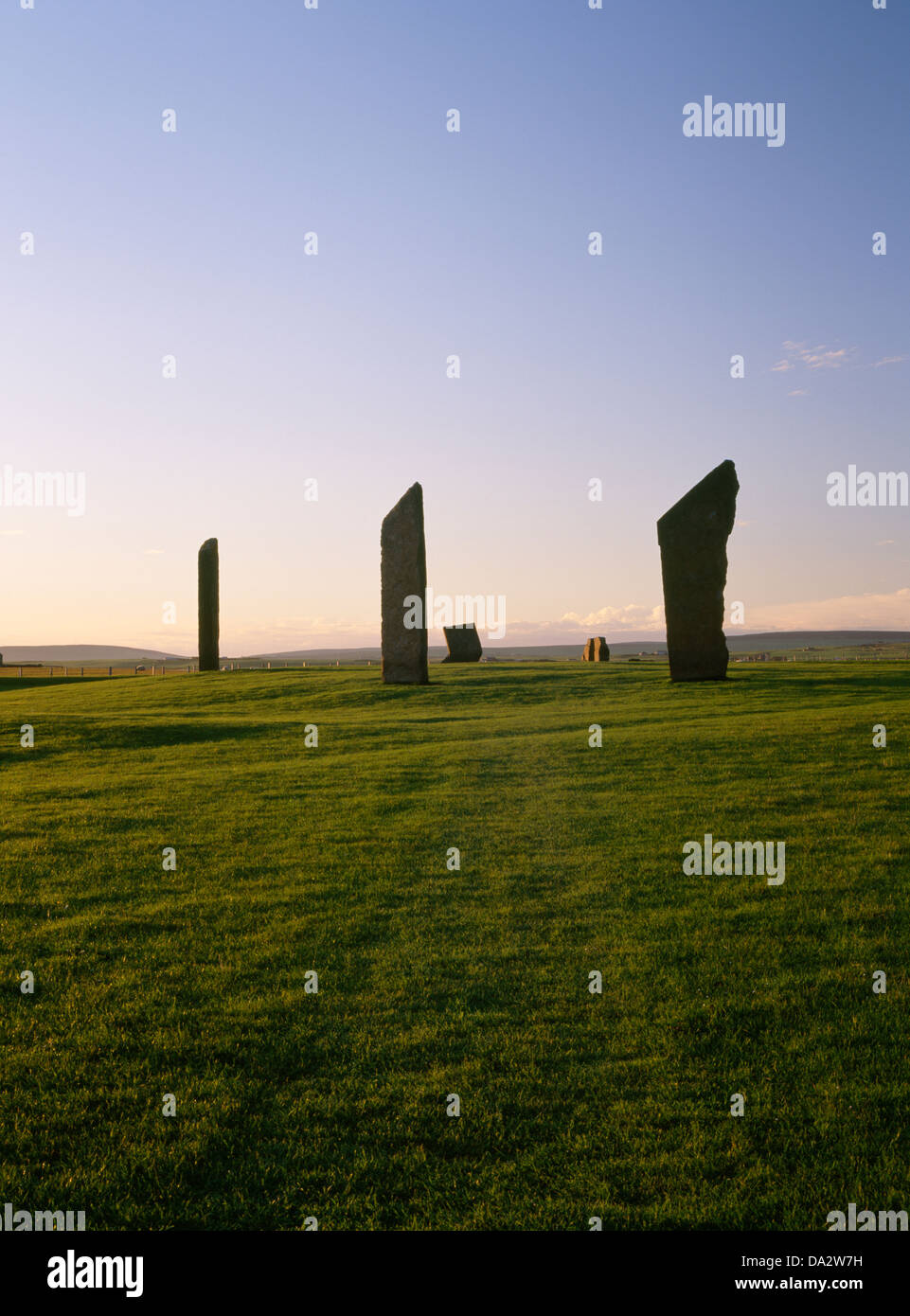 The Stones of Stenness stone circle, Mainland, Orkney, standing within the remains of a circular earthwork henge monument shown up by evening sunshine Stock Photo