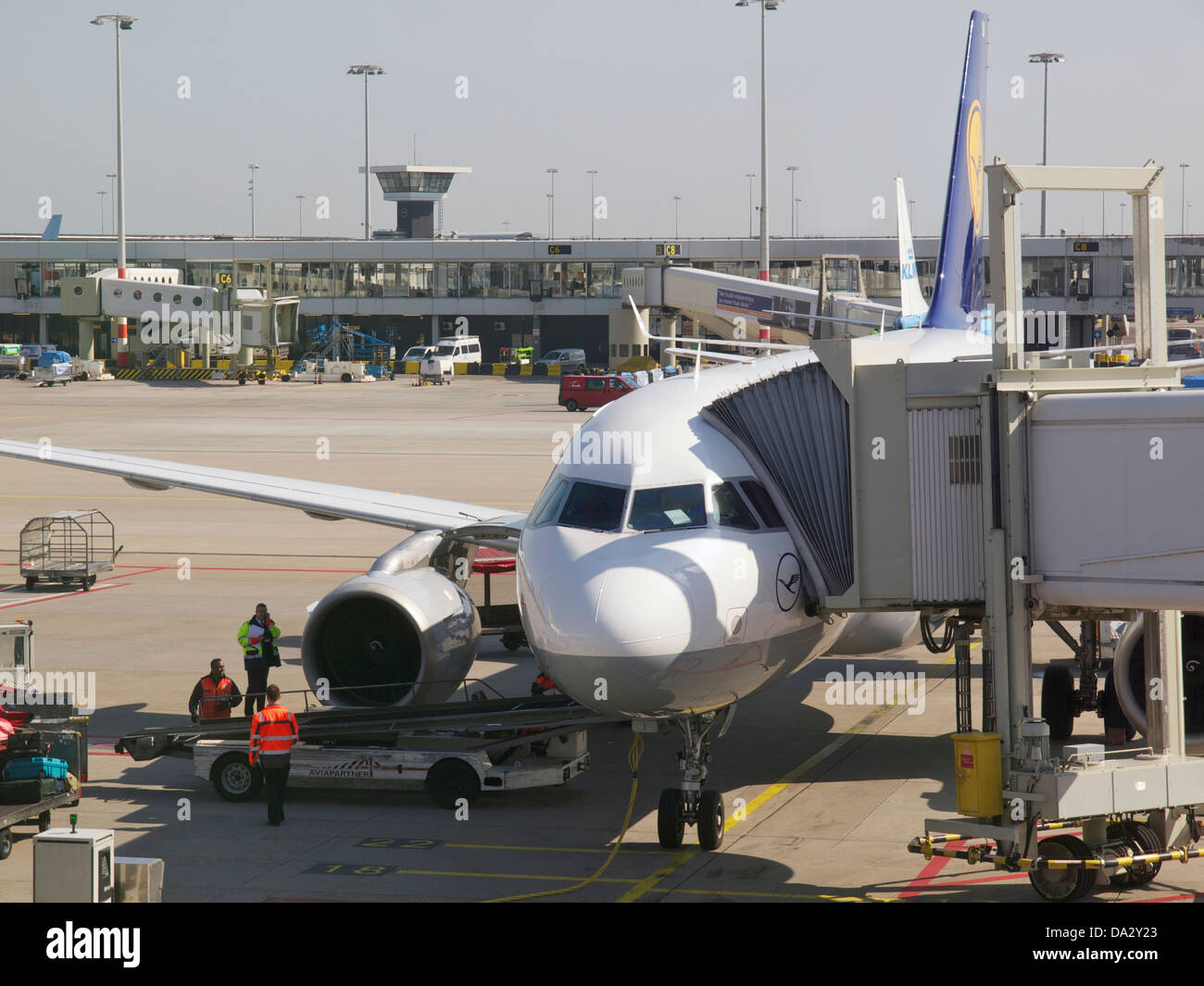 Docked Lufthansa aeroplane at the Lisbon airport, with ground personnel doing checks. Portugal Stock Photo