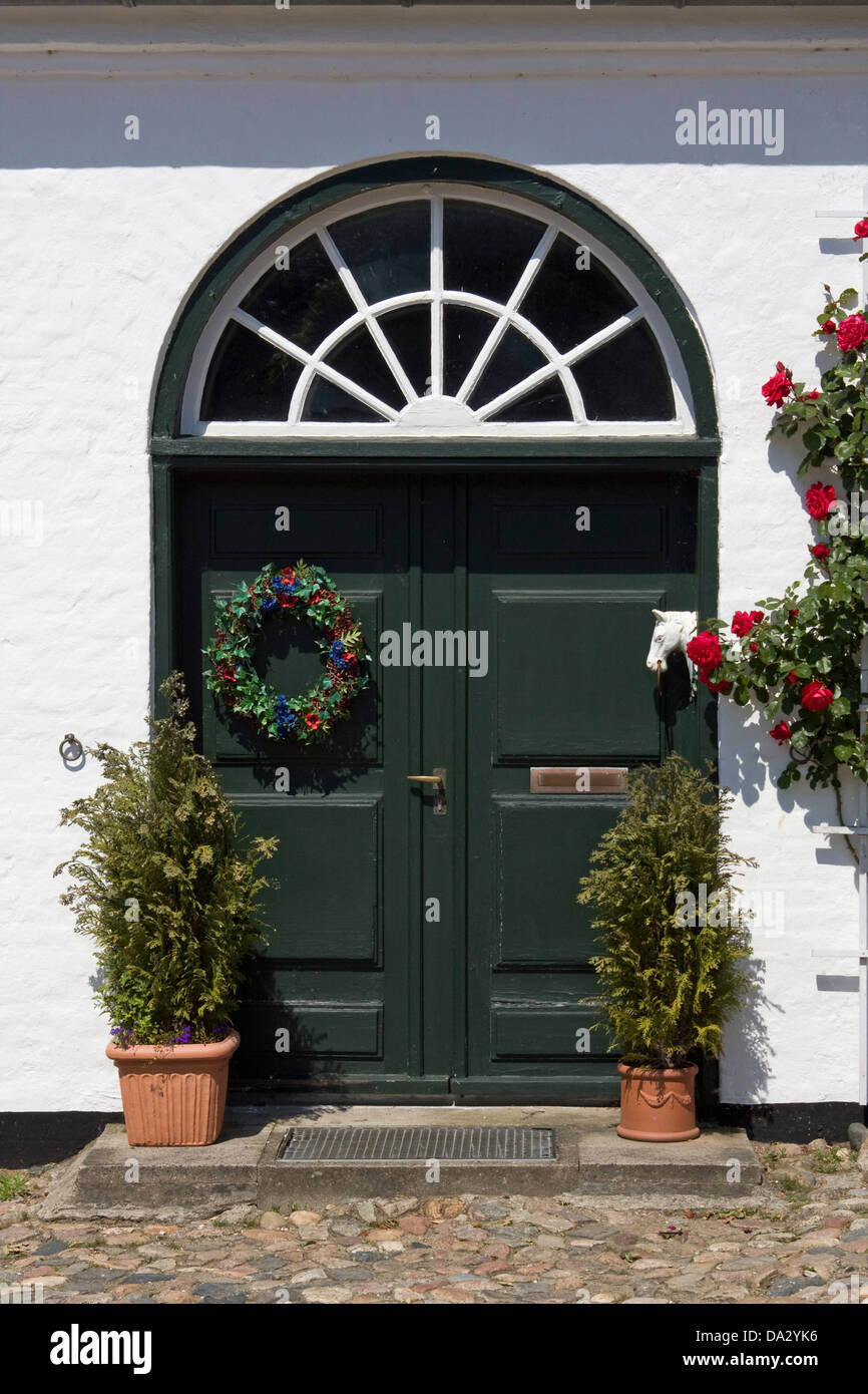 Europe, Germany, Schleswig Holstein, Gluecksburg, Gluecksburg Castle, Gatehouse, historical entrance door with climbing roses Stock Photo